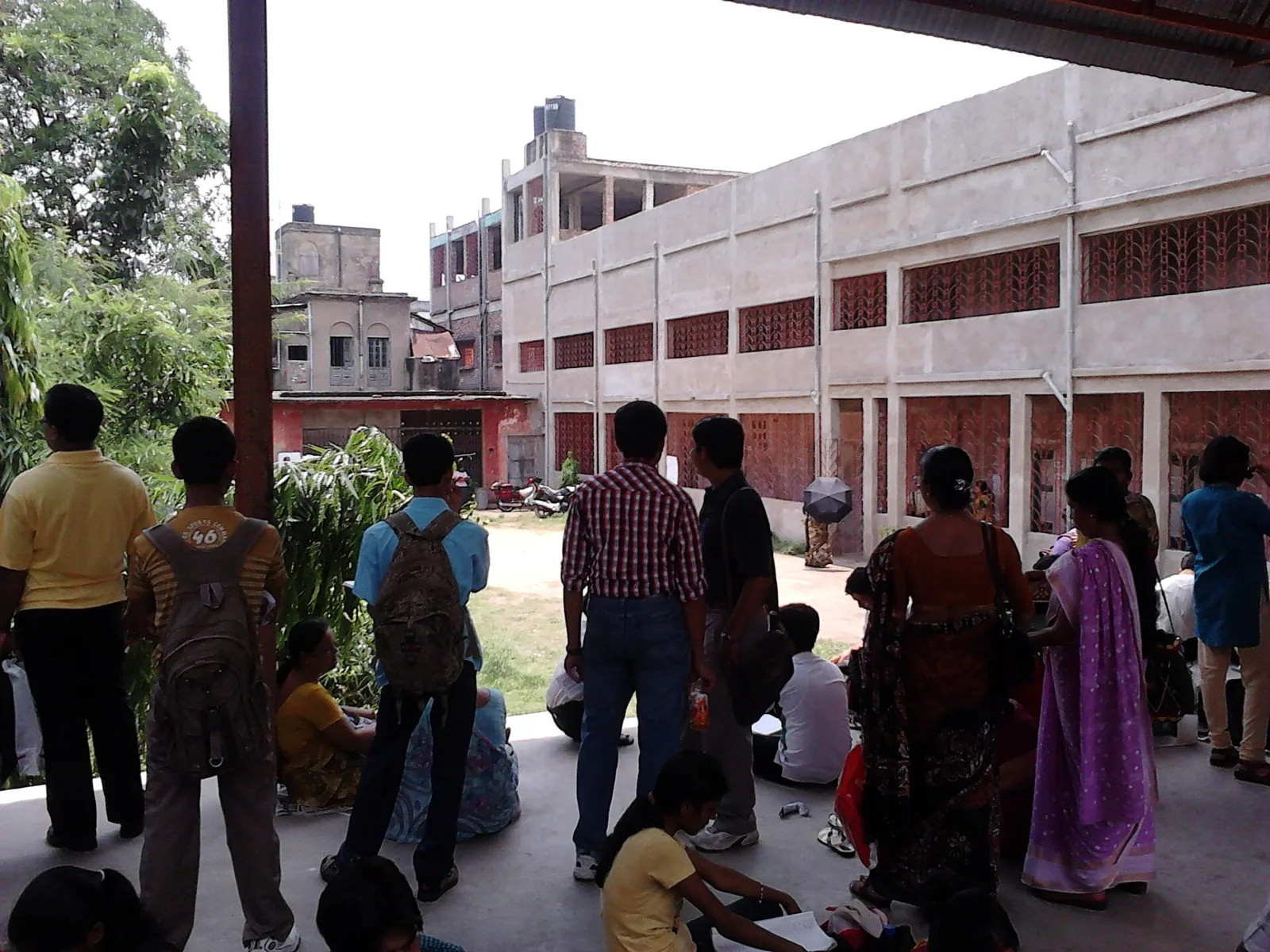 Candidates waiting under a shed at an entrance exam centre in Howrah, 2011
