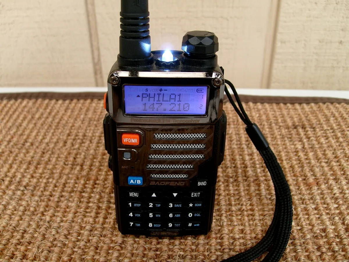 Handheld walkie-talkie with its operating frequency shown on the screen, file photo