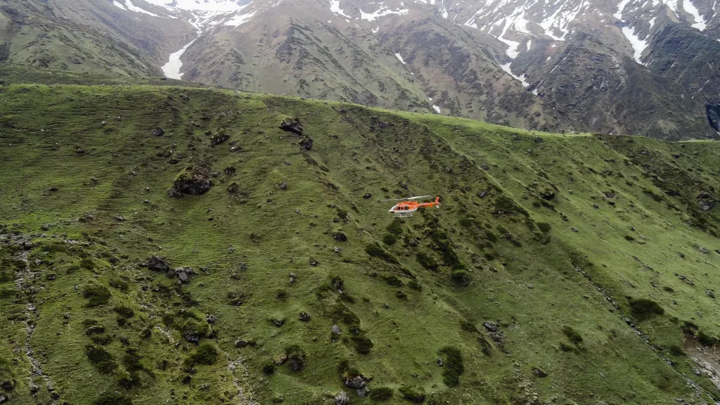 Helicopter flying over a green Himalayan slope on a pilgrim route, file photo for the Uttarakhand chopper crash