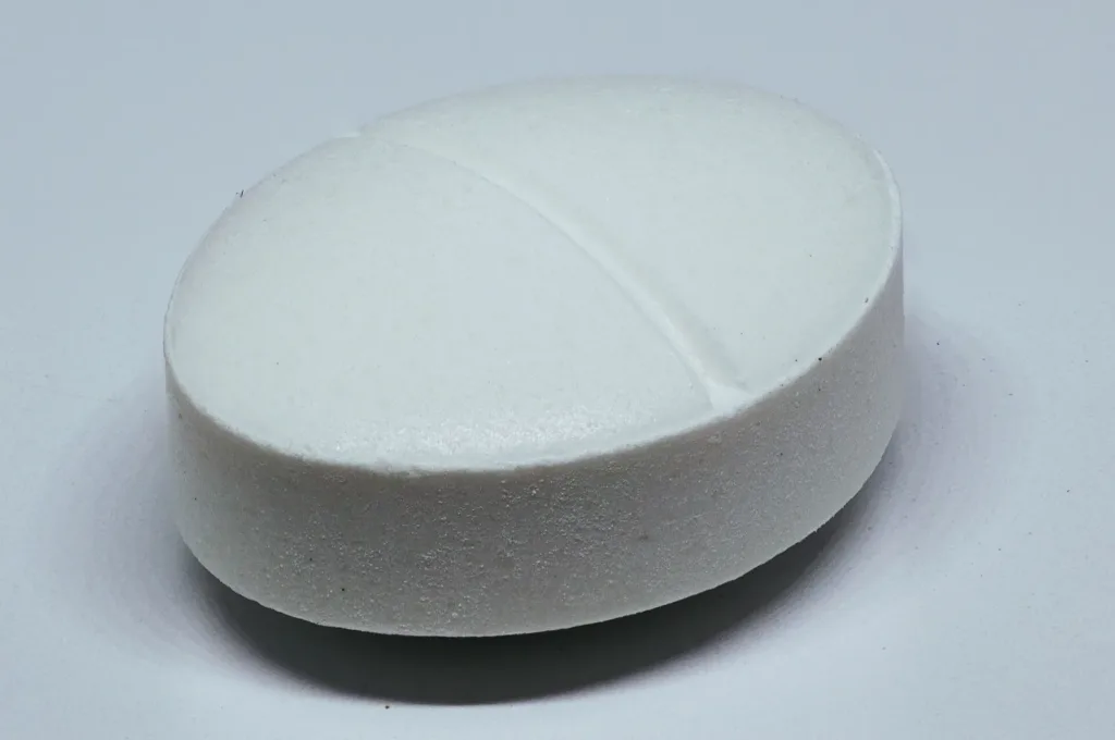 Medicine prices: a single white generic medicine tablet in close-up, file photo