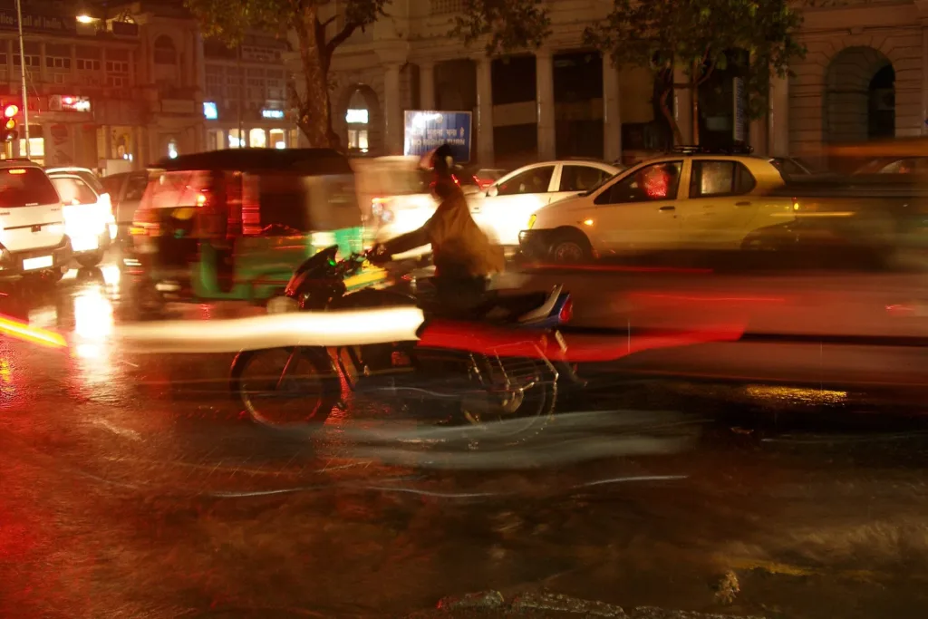 NDMC parking plan: cars and an autorickshaw in Connaught Place traffic at night, file photo
