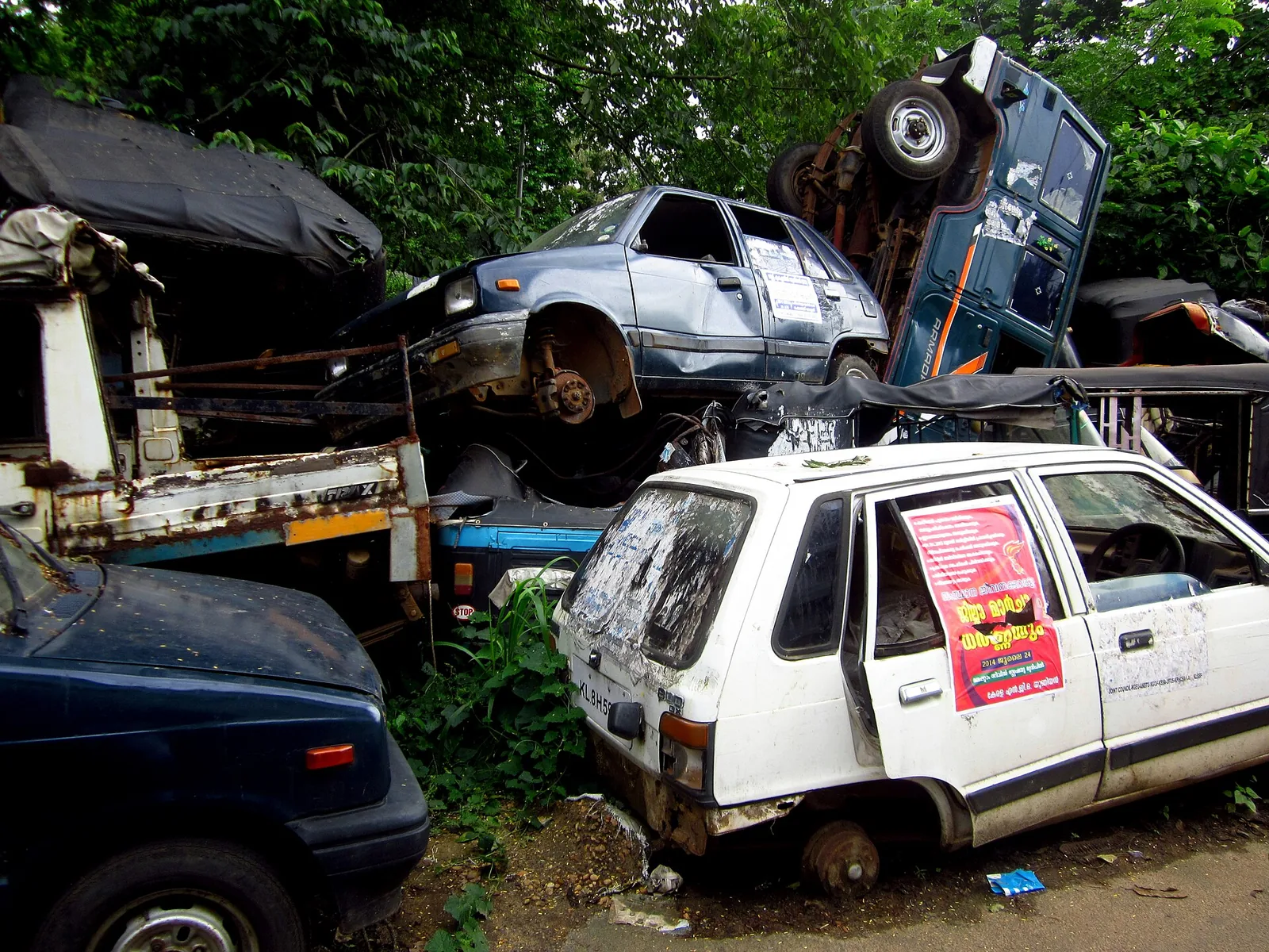 Old scrapped cars piled at a scrap yard, vehicle scrapping file photo