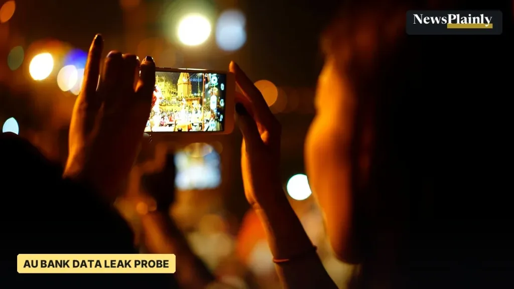 Person filming on a smartphone at night, representative image for the AU Bank data leak probe