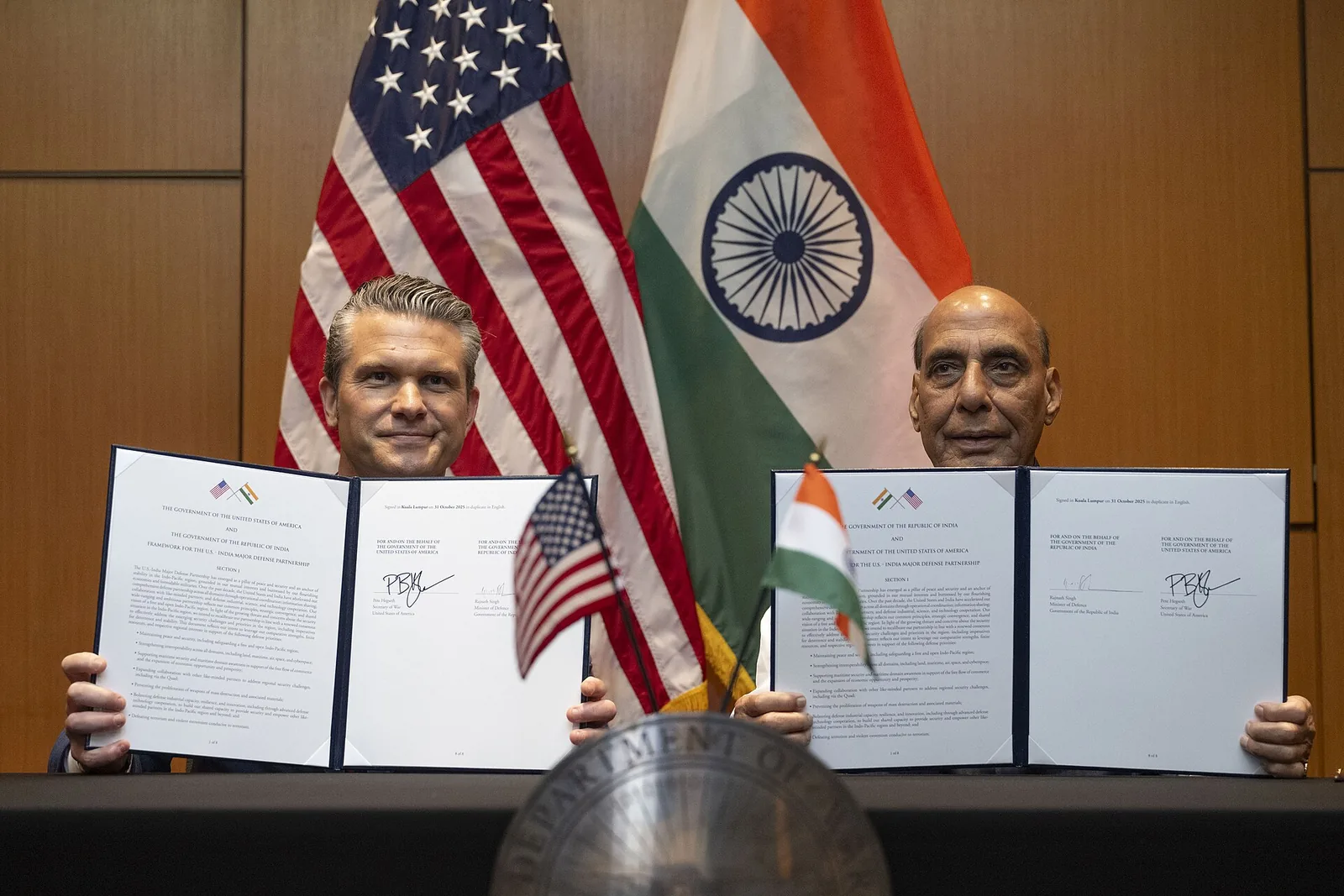 Pete Hegseth and Rajnath Singh hold up the signed India-US defence framework in Kuala Lumpur, 31 October 2025