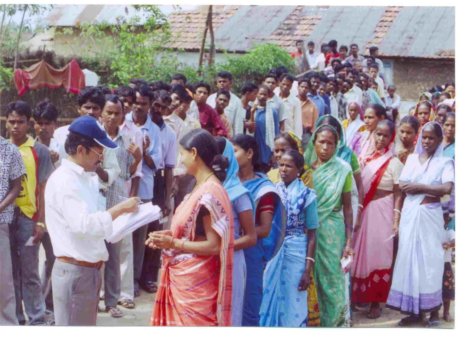 Polling officer checking voter ID cards of people queued to vote in West Bengal, 2006 file photo