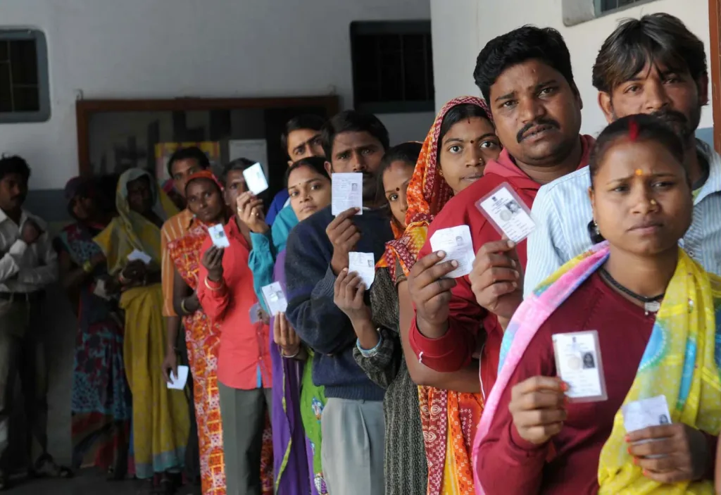 SIR software row: voters holding voter ID cards in a queue in Bhopal, 2013 file photo