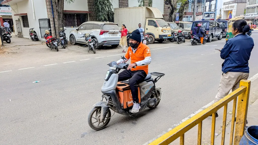 Swiggy delivery partner riding a scooter in Bengaluru, gig workers social security board