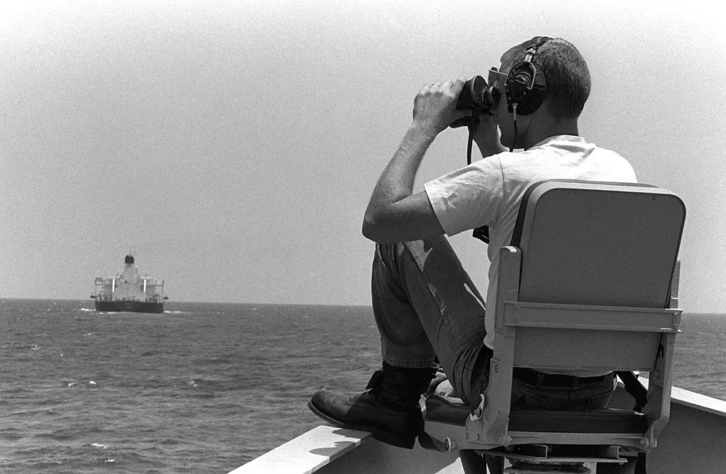 US Navy lookout watching an oil tanker in the Persian Gulf, as Iran makes new Hormuz mines claims