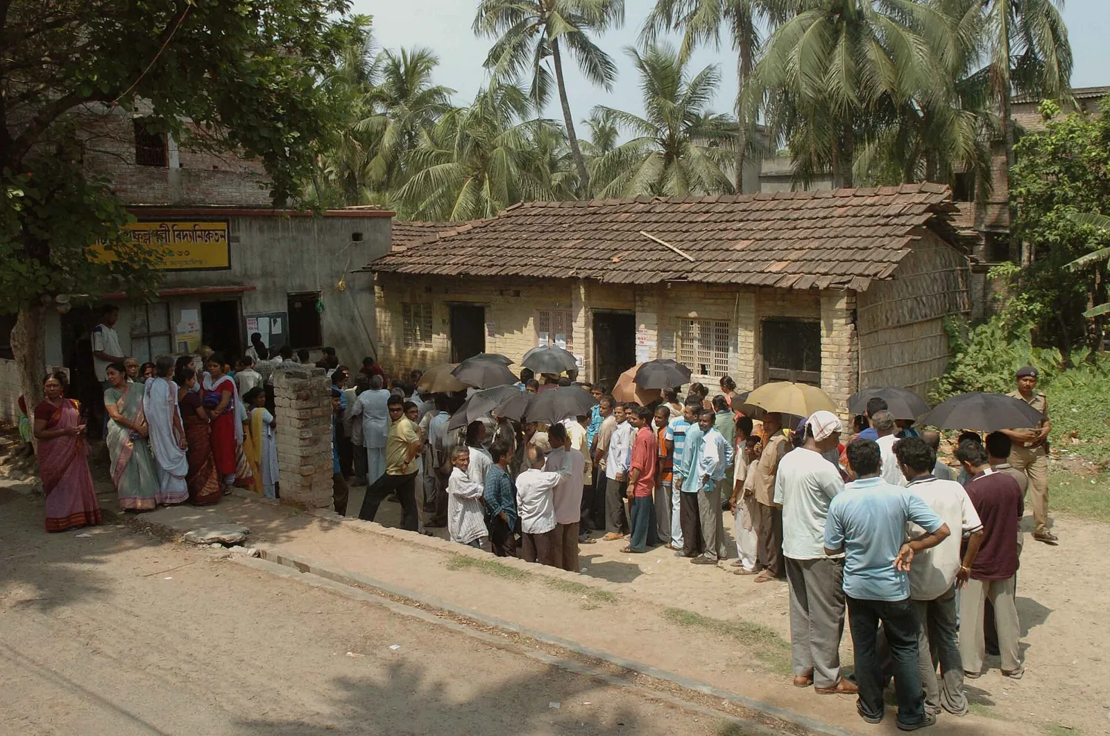 Voters queue at a polling booth in Belgharia, West Bengal, April 2006 file photo