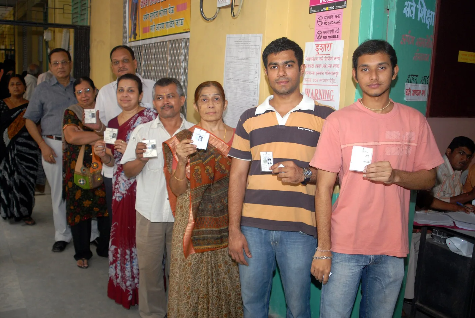 Voters show identity cards at a Mumbai polling booth in 2009, file photo